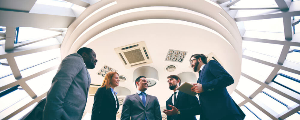 Five people chatting after a work meeting