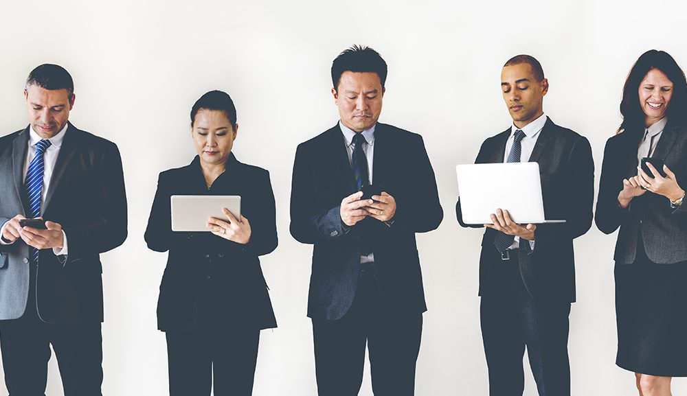 Five people using their electronic devices